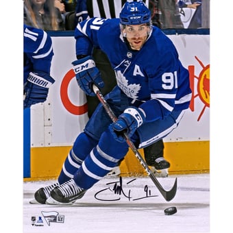 John Tavares Toronto Maple Leafs Autographed 8" x 10" Blue Jersey Skating with Puck Vertical Photograph