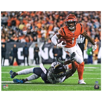 Ja'Marr Chase Cincinnati Bengals Autographed 16'' x 20'' Orange Breaking Tackle Photograph